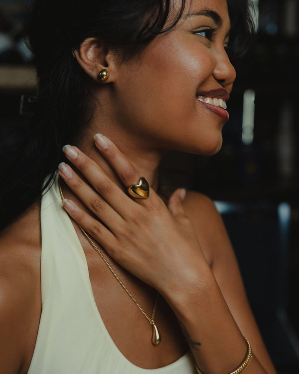 Nalla Studs by Umutoni. Minimal gold stud earrings inspired by playfulness and simplicity, handcrafted in Kenya using traditional techniques. Elegant, timeless, and meaningful.
