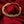 Load image into Gallery viewer, Gold chain bracelet with intricate interwoven links, elegantly displayed on rich red satin fabric.
