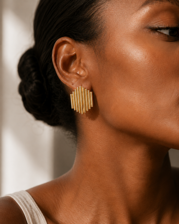 Close up - Model wearing Umutoni Asani gold earrings, handmade in Kenya.