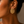 Load image into Gallery viewer, Close up - Model wearing Umutoni Asani gold earrings, handmade in Kenya.

