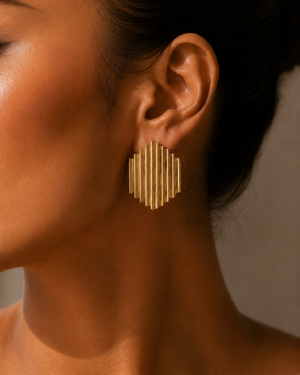 Close up - Model wearing Umutoni Asani gold earrings, handmade in Kenya.