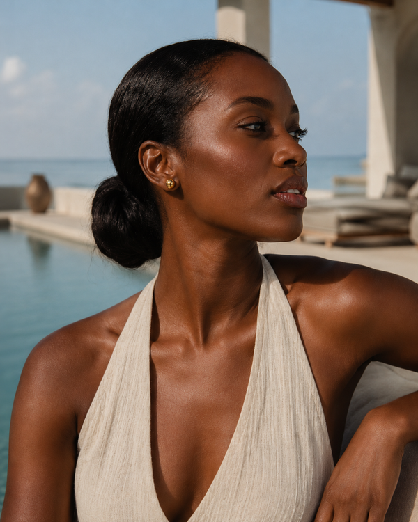 Model wearing Umutoni Nalla stud gold earrings, handmade in Kenya.