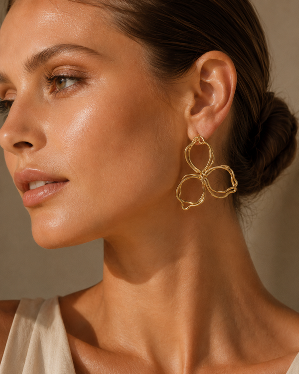 Model wearing Umutoni petali gold flower earrings with elevated everyday styling.