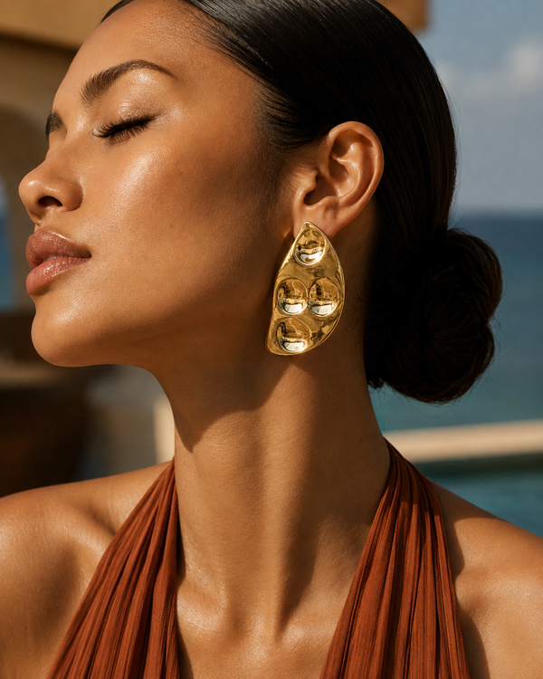 Model wearing Umutoni Terema gold earrings, handmade in Kenya.